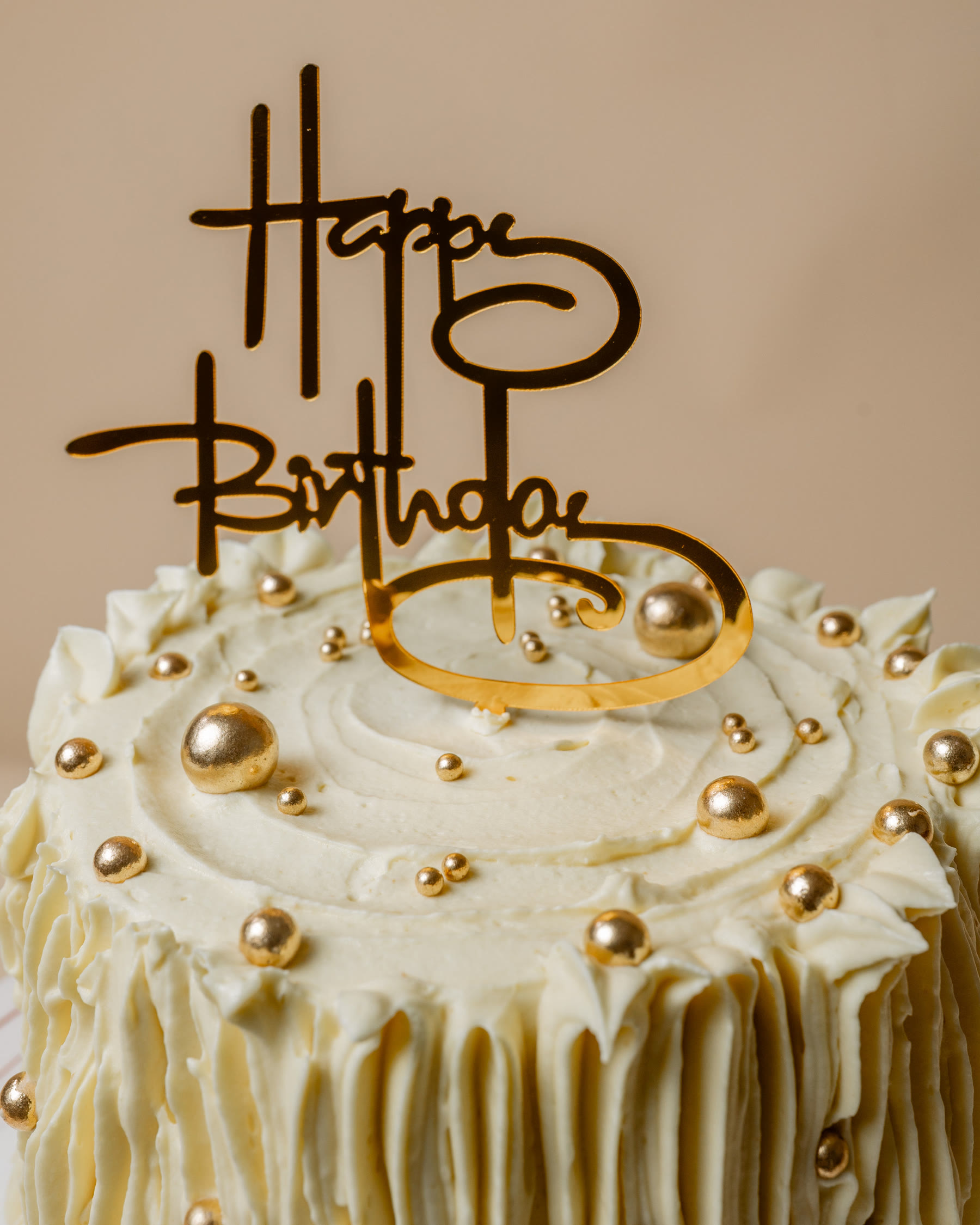 Birthday cake with gold pearls