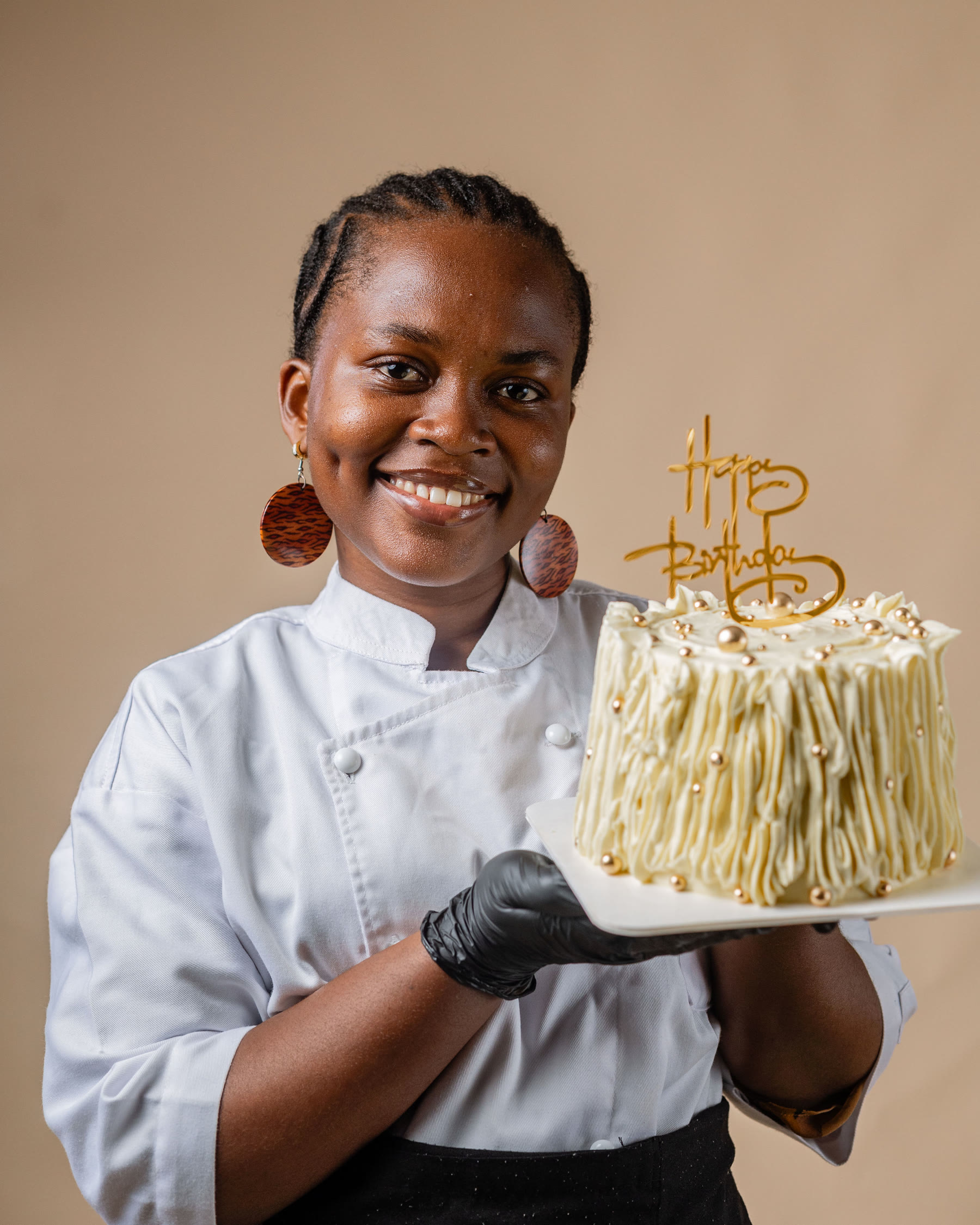 Chef Safoa decorating a finished cake
